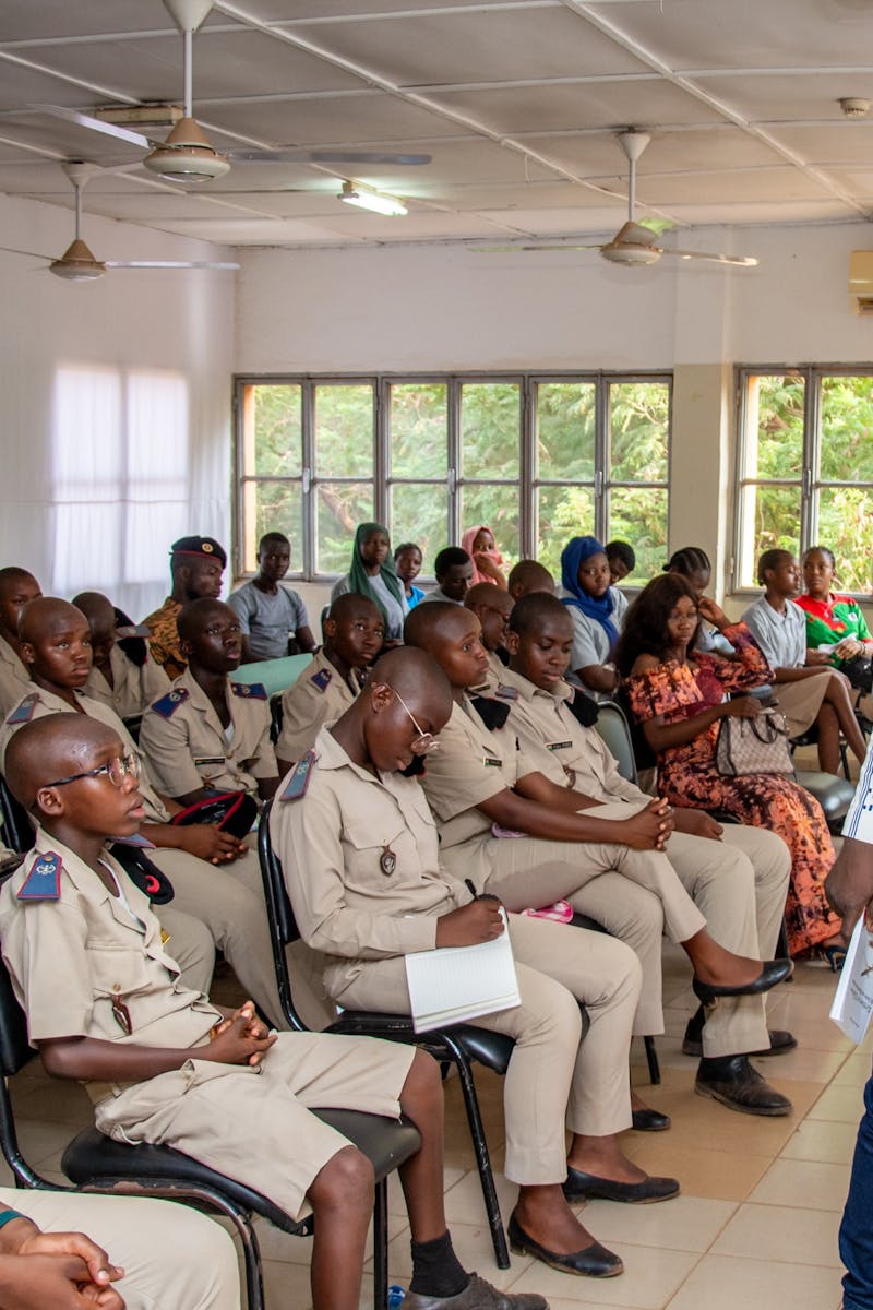 Instructor leads a session with students in uniform. Classroom setting.